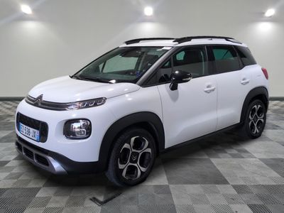 a white citrole is parked in a large room