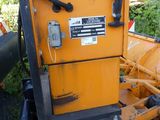 a yellow machine that is sitting in the grass