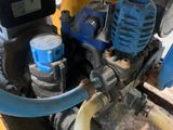a machine that is sitting on a pallet with a hose