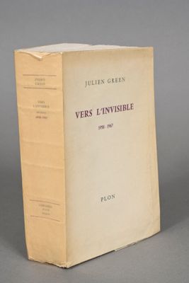 an old book sitting on top of a table on a gray surface