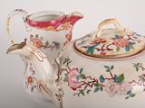 a tea pot and a tea pot sitting on a table