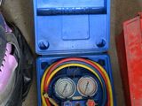 two air compressors and a tool box on the floor
