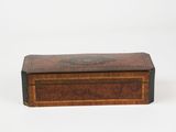 an antique wooden box with a decorative design on the lid