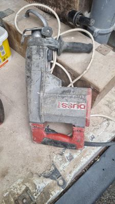 a red and black nail grinder sitting on a table