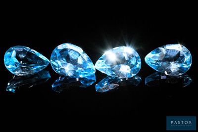 a group of three blue diamonds on a black background