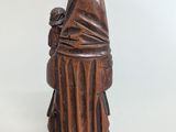 an old wooden statue of a woman with a veil on her head