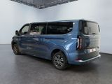 the rear view of a blue minivan parked in a white room