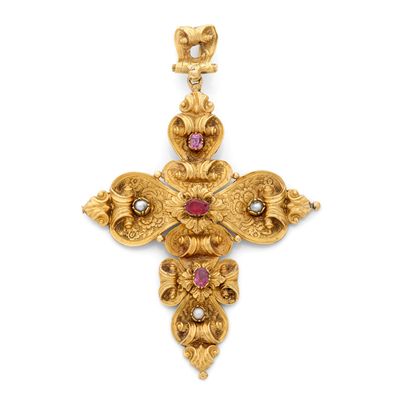 un pendentif en forme de croix en or et rubis