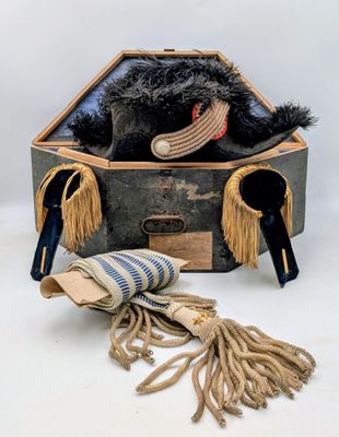 a teddy bear sitting inside of a suitcase with a hat on top of it