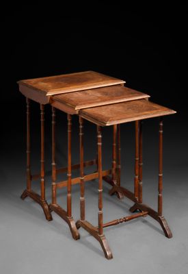 a set of three walnut nesting tables with turned legs