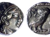 a close up of a coin with an owl on it