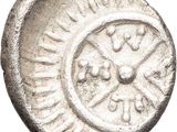 a silver coin with a circular design on it