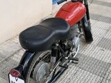 a red and black motorcycle parked on the side of the street
