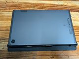 a laptop sitting on top of a wooden table
