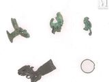 several pieces of bronze are displayed on a white surface
