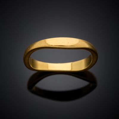 a close up of a gold ring on a black surface