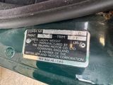 a close up of a green car with a label on it
