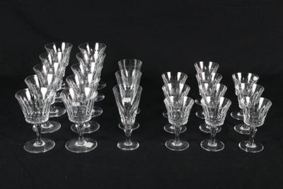 a set of twelve crystal wine glasses on a black background