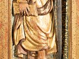 statue of a man holding a sword and a shield in a wooden frame
