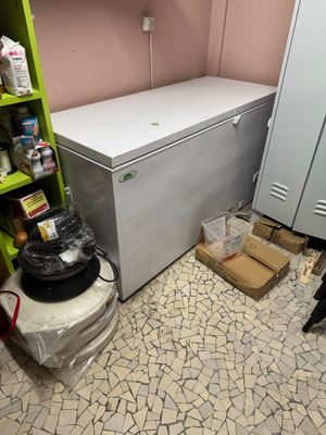 a refrigerator and a freezer in a small room