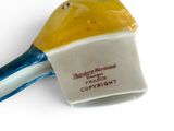 a yellow and blue spatula on a white surface