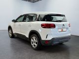 the rear end of a white citrole parked in a garage