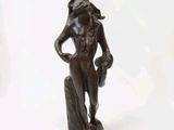 a bronze statue of a woman holding a bird on her shoulder