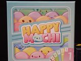 a box of happy mochi next to a box of candy