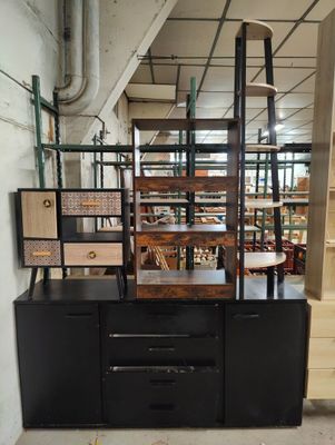 a black cabinet with shelves and drawers in a room