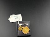 a close up of a piece of jewelry with a tag on it