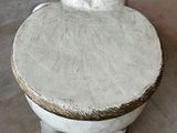 a small white stool with two cats on top of it
