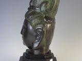 sculpture of a woman ' s head on a black base