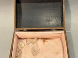a wooden box with a key in it on a wall