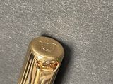 a close up of a gold colored metal object on a surface