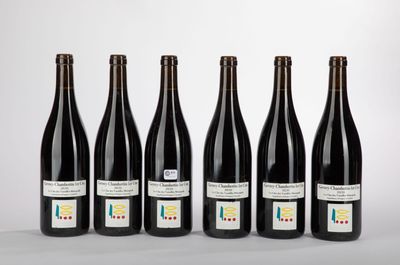 six bottles of wine lined up in a row on a table