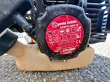 the back end of a lawn mower with a red and black sticker on it