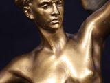 a bronze statue of a man holding a bowl