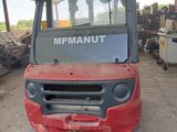 a picture of a red forklift parked in a warehouse