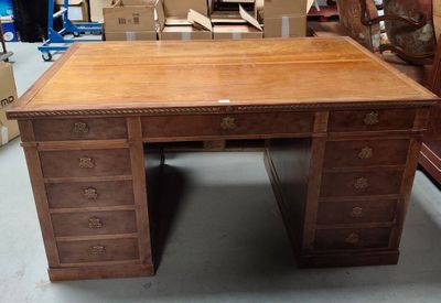 a wooden desk with drawers on it in a room