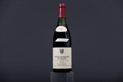 a bottle of wine sitting on top of a glass table