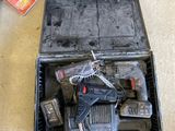 someone standing next to a tool case filled with tools on the floor