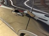a close up of a car door handle with a sticker on it