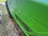 a close up of a green car parked on the side of the road