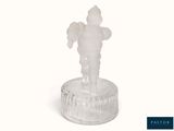 a glass figurine of a man on a pedestal
