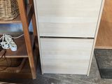a wooden cabinet with a basket on top of it
