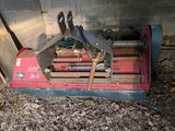 a red machine that is sitting in the dirt