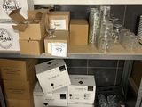 many boxes and glasses on a shelf in a room