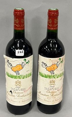 two bottles of red wine sitting next to each other on a table