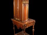 a small wooden table with a mirror on top of it