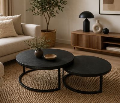 two tables that are sitting on a rug in a living room